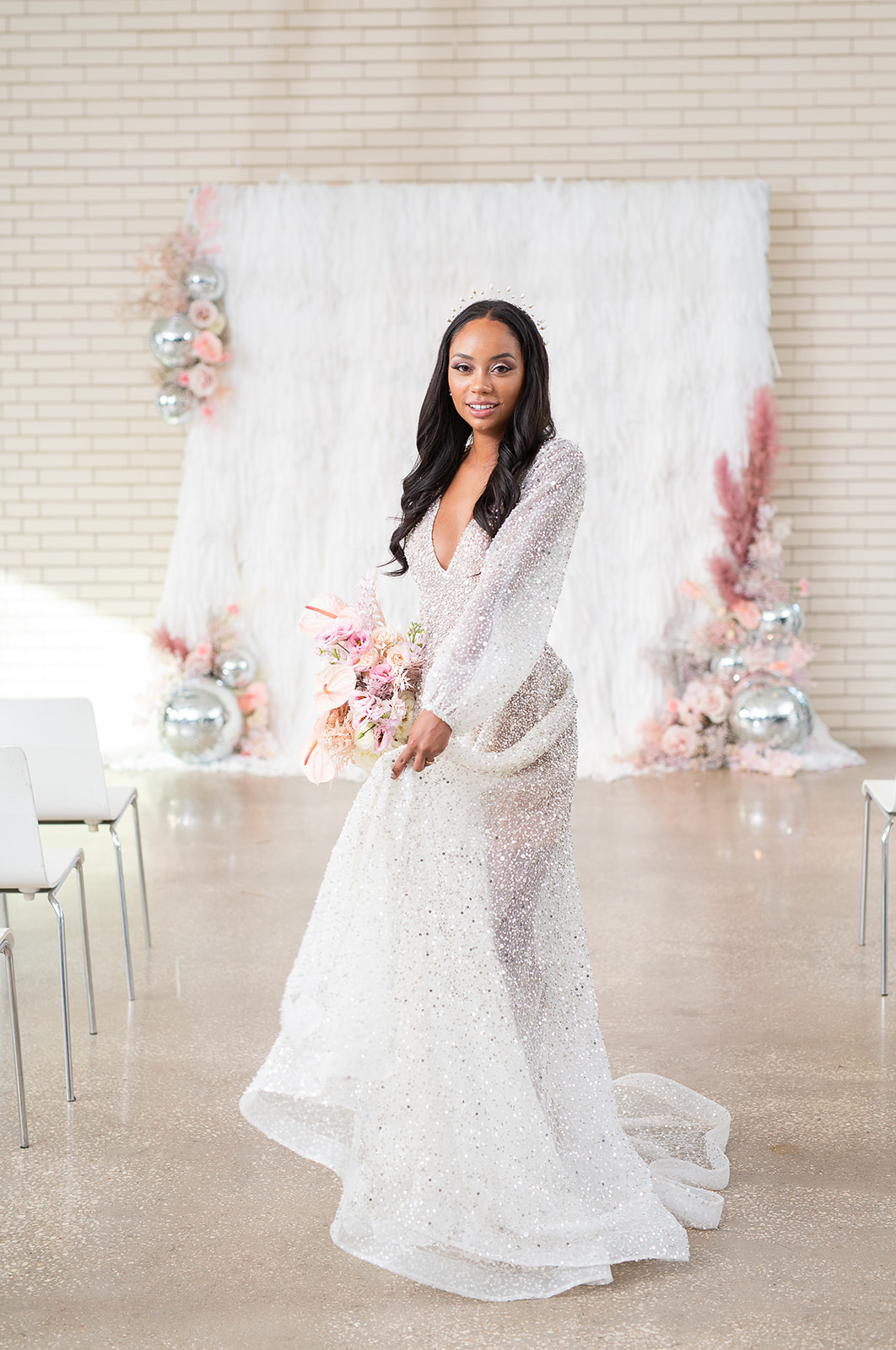 Black bride posing in a white wedding dress